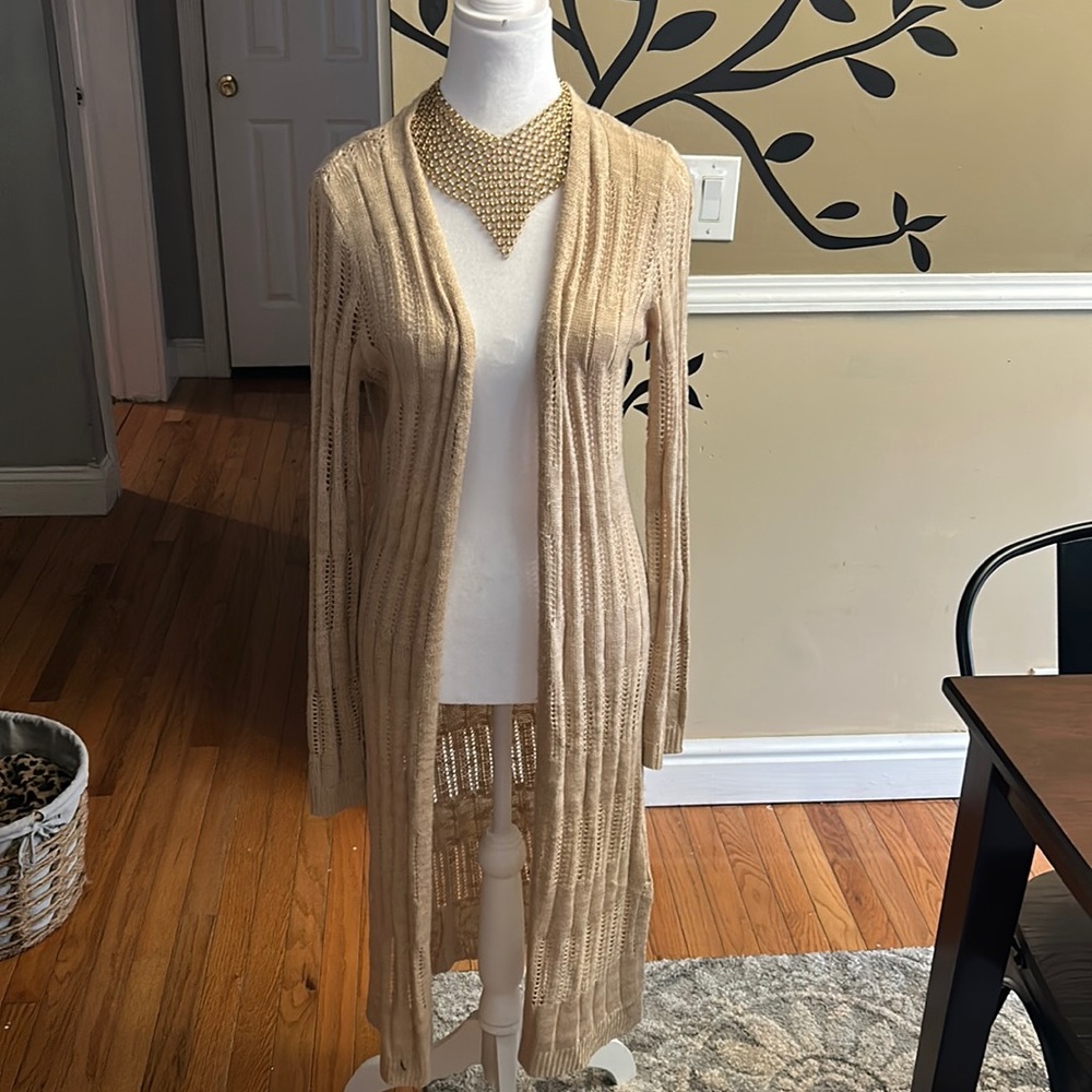 Long cream colored cardigan sweater.. With necklaces